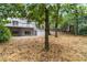 View of the home's exterior from the backyard with a view of the deck and green space at 3009 Gant Quarters Dr, Marietta, GA 30068