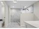 Elegant bathroom with marble tile, glass shower with rain shower head and white countertops at 3009 Gant Quarters Dr, Marietta, GA 30068