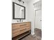 Bright bathroom with modern vanity, black fixtures and wood look plank flooring at 3009 Gant Quarters Dr, Marietta, GA 30068