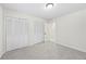 A simply decorated, neutral-colored bedroom with gray carpet, a closet and a white door at 3009 Gant Quarters Dr, Marietta, GA 30068