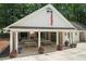 View of the community clubhouse featuring an outdoor fireplace and picnic tables for residents to enjoy at 3009 Gant Quarters Dr, Marietta, GA 30068