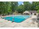 Wide shot of the long community pool with lounge chairs and a clubhouse at 3009 Gant Quarters Dr, Marietta, GA 30068