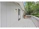 A side view of the deck with a railing, a door to the home, and exterior lighting at 3009 Gant Quarters Dr, Marietta, GA 30068