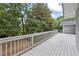 A side view of the wooden deck, with a railing overlooking a treed lot at 3009 Gant Quarters Dr, Marietta, GA 30068