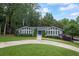 Inviting one-story home featuring a striking blue front door and a lush green lawn at 3009 Gant Quarters Dr, Marietta, GA 30068