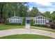 Charming home with a well-manicured lawn, lovely landscaping, and a welcoming blue double-door entry at 3009 Gant Quarters Dr, Marietta, GA 30068