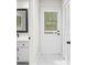 Hallway leading to back door with sink and mirror on the left and white closet on the right at 3009 Gant Quarters Dr, Marietta, GA 30068