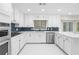 Stylish kitchen featuring white cabinetry, quartz countertops, and modern stainless steel appliances at 3009 Gant Quarters Dr, Marietta, GA 30068