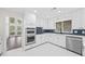 Bright kitchen features white cabinets, stainless steel appliances, sleek countertops, and eye-catching backsplash at 3009 Gant Quarters Dr, Marietta, GA 30068