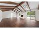 Living room with wood floors, exposed beams, skylights, stone fireplace, and deck access at 3009 Gant Quarters Dr, Marietta, GA 30068