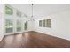Sun-filled living room showcasing hardwood floors, shuttered windows, and a modern chandelier at 3009 Gant Quarters Dr, Marietta, GA 30068
