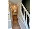 View of the home's hallway leading to the kitchen, featuring wood floors and staircase at 354 Dublin Way, Lawrenceville, GA 30044