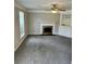 Carpeted living room featuring a fireplace and built-in shelving at 354 Dublin Way, Lawrenceville, GA 30044