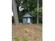 View of a backyard outbuilding with covered porch and green surroundings at 354 Dublin Way, Lawrenceville, GA 30044