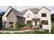 Beautiful home featuring a brick facade, manicured landscaping, and a charming front porch at 3680 Tanglewood Se Dr, Atlanta, GA 30339