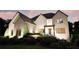 Elegant brick home with stylish dark roof, well-kept landscaping, and sophisticated outdoor lighting at 3680 Tanglewood Se Dr, Atlanta, GA 30339