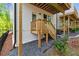 Outdoor porch featuring wooden stairs, pea gravel, and a black iron fence at 586 Avondale Park Cir, Decatur, GA 30032
