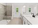 Dual vanity bathroom with modern walk-in shower and tile floors at 586 Avondale Park Cir, Decatur, GA 30032