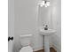 Modern bathroom featuring a pedestal sink, a white toilet, and matte black finishes at 586 Avondale Park Cir, Decatur, GA 30032
