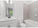 Bathroom with gray tiling, a bathtub, toilet, vanity, and a sink at 586 Avondale Park Cir, Decatur, GA 30032