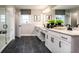 Modern bathroom with dual sinks, sleek black fixtures, and glass-enclosed shower offers a spa-like experience at 586 Avondale Park Cir, Decatur, GA 30032