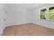 Bedroom with hardwood flooring, a window, and bright white walls at 586 Avondale Park Cir, Decatur, GA 30032