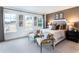 Bright bedroom with neutral color scheme, comfortable seating, and ample natural light from three large windows at 586 Avondale Park Cir, Decatur, GA 30032