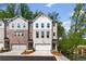 Townhome community featuring attached garages, sidewalks, and professionally landscaped lawns at 586 Avondale Park Cir, Decatur, GA 30032
