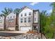 A modern brick and painted brick townhome with attached garages and professionally landscaped yard at 586 Avondale Park Cir, Decatur, GA 30032