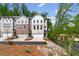 Townhome community with professionally landscaped yards, driveways, and single-car garages at 586 Avondale Park Cir, Decatur, GA 30032