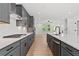 Modern kitchen featuring gray cabinets, stainless steel appliances, and a white tile backsplash for a sleek look at 586 Avondale Park Cir, Decatur, GA 30032
