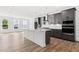 Open kitchen area with a large island, gray cabinetry, stainless appliances, and hardwood floors, perfect for entertaining at 586 Avondale Park Cir, Decatur, GA 30032