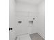 Functional laundry area featuring tile floors and a wire shelf at 586 Avondale Park Cir, Decatur, GA 30032