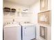 Efficient laundry room with washer, dryer, and decorative leaf art at 586 Avondale Park Cir, Decatur, GA 30032
