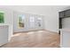 Spacious living room featuring hardwood floors and three large windows providing ample natural light at 586 Avondale Park Cir, Decatur, GA 30032