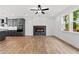 Bright living room featuring a modern electric fireplace, wood flooring and open concept to the kitchen at 586 Avondale Park Cir, Decatur, GA 30032