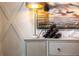 Chic sideboard with designer lamp, wine rack, decorative bottles, and an artistic painting, adding a touch of sophistication at 586 Avondale Park Cir, Decatur, GA 30032
