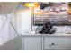 Chic sideboard with designer lamp, wine rack, decorative bottles, and an artistic painting, adding a touch of sophistication at 586 Avondale Park Cir, Decatur, GA 30032