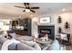 Stylish living room featuring a modern fireplace, comfortable gray sofa, and open kitchen concept at 586 Avondale Park Cir, Decatur, GA 30032