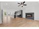 Bright living room featuring a modern electric fireplace, wood flooring and open concept to the kitchen at 586 Avondale Park Cir, Decatur, GA 30032