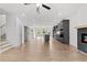 Open-concept living area featuring hardwood floors, a modern fireplace, and an adjacent kitchen at 586 Avondale Park Cir, Decatur, GA 30032