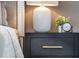Close up image of lamp, clock, and flowers on a nightstand with gold hardware at 586 Avondale Park Cir, Decatur, GA 30032