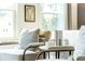 Sitting area has chairs with decorative pillows, small table, and view to outdoors through the window at 586 Avondale Park Cir, Decatur, GA 30032