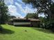 Back exterior view of a brick home featuring a screened-in porch and sloping lawn at 1046 Waterside Se Dr, Conyers, GA 30013