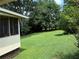 Large backyard with lush lawn surrounding the property at 1046 Waterside Se Dr, Conyers, GA 30013