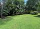 Expansive backyard featuring lush green grass and mature trees, perfect for outdoor activities and relaxation at 1046 Waterside Se Dr, Conyers, GA 30013
