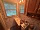 Bathroom featuring a sink, mirror, and window with natural lighting at 1046 Waterside Se Dr, Conyers, GA 30013