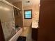 Bathroom featuring a shower-tub combo, vanity, and a window for natural light at 1046 Waterside Se Dr, Conyers, GA 30013