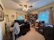 Cozy bedroom featuring a ceiling fan, window with drapes, and a cluttered desk at 1046 Waterside Se Dr, Conyers, GA 30013