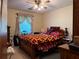 Cozy bedroom featuring a ceiling fan and a window with decorative curtains at 1046 Waterside Se Dr, Conyers, GA 30013